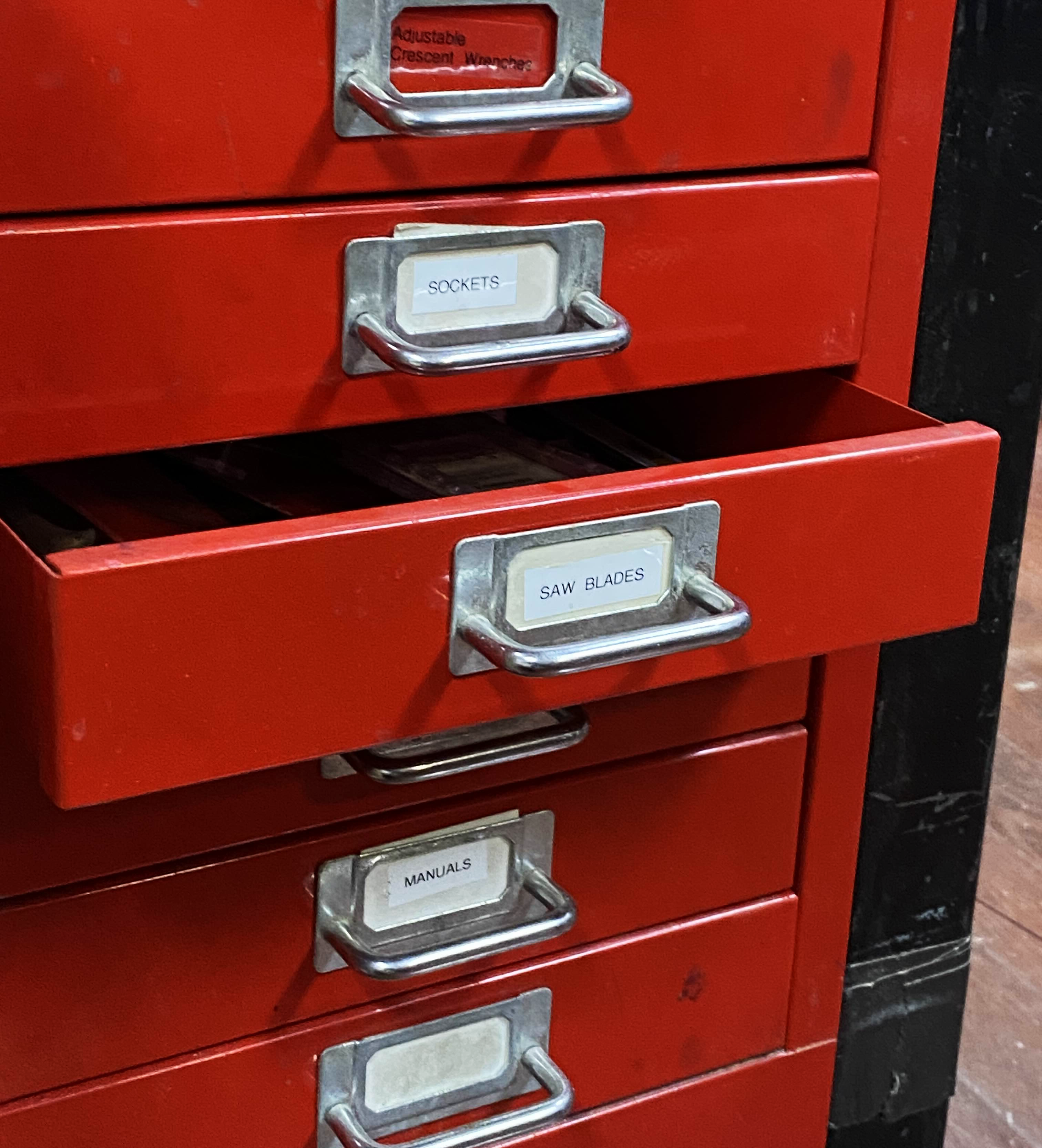 a red drawer labeled for saw blades